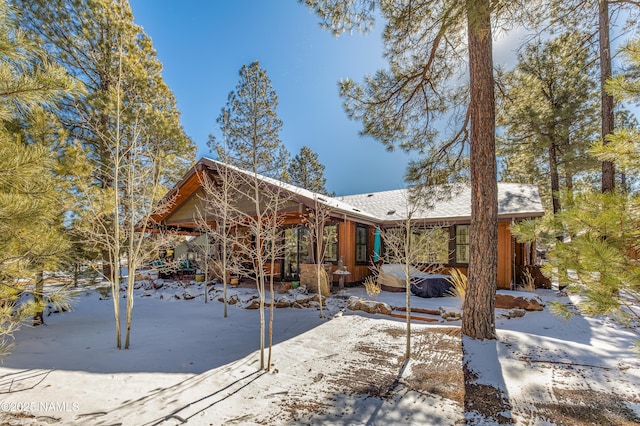 snow covered property featuring a hot tub