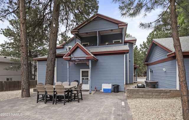 3380 E Lockett Rd, Flagstaff, AZ 86004 - rear view of property featuring a patio area, outdoor dining space, a balcony, and a shingled roof