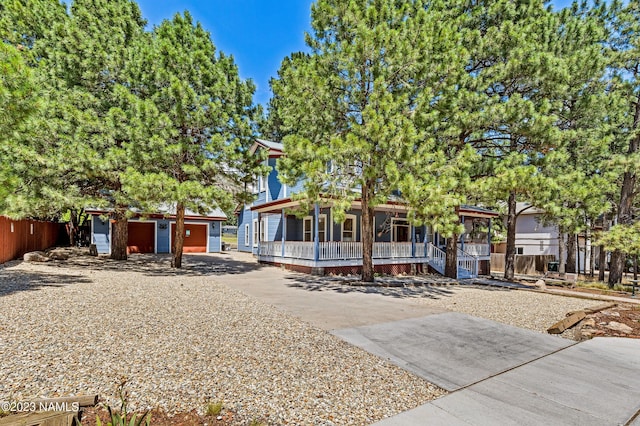 3380 E Lockett Rd, Flagstaff, AZ 86004 - view of front of home with covered porch, an outdoor structure, and concrete driveway