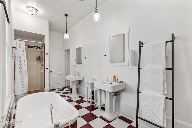 3380 E Lockett Rd, Flagstaff, AZ 86004 - full bathroom featuring tile patterned floors, a soaking tub, a tile shower, baseboards, and a sink
