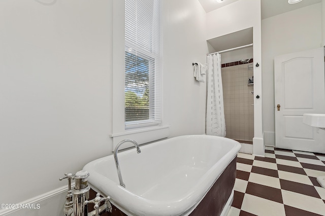 3380 E Lockett Rd, Flagstaff, AZ 86004 - bathroom featuring tile patterned floors, a freestanding bath, and tiled shower