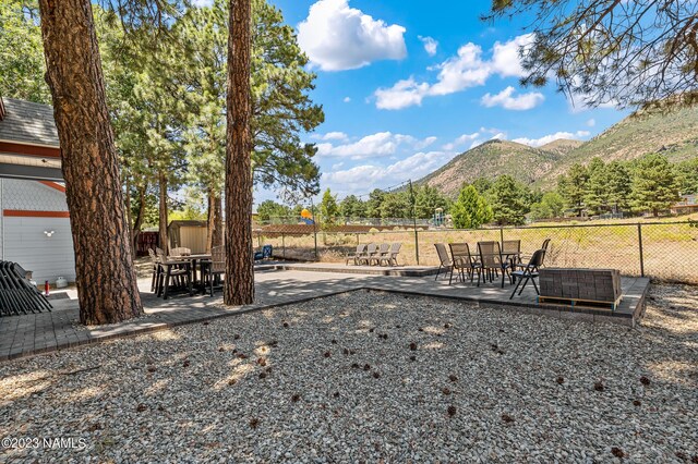 3380 E Lockett Rd, Flagstaff, AZ 86004 - view of yard featuring a mountain view, a patio, and outdoor dining space