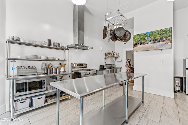 3380 E Lockett Rd, Flagstaff, AZ 86004 - kitchen with appliances with stainless steel finishes, wall chimney exhaust hood, a high ceiling, and light marble finish flooring