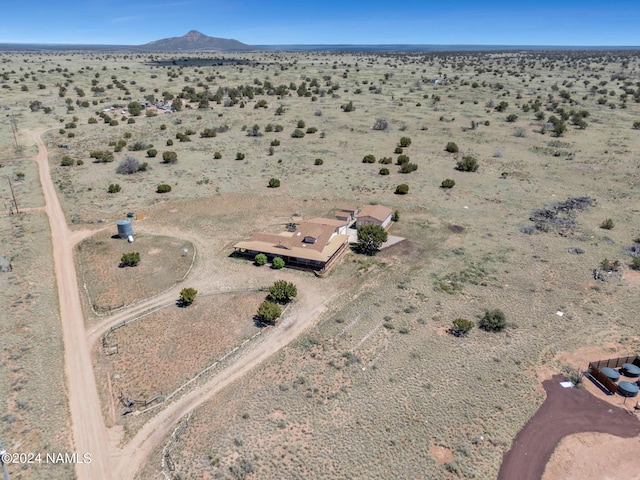 drone / aerial view featuring view of desert and a mountain view