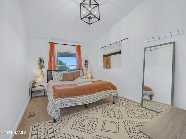 carpeted bedroom featuring an inviting chandelier, baseboards, visible vents, and vaulted ceiling