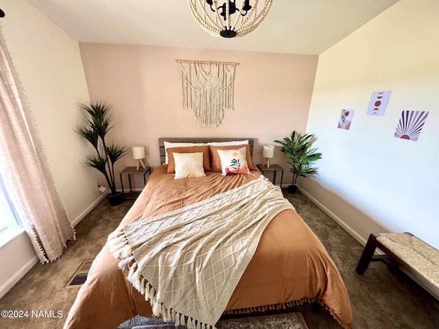 carpeted bedroom featuring visible vents, a notable chandelier, and baseboards