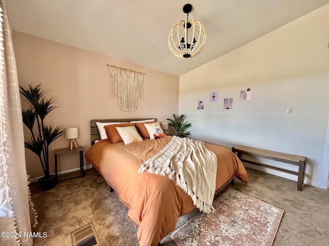 carpeted bedroom with lofted ceiling, an inviting chandelier, baseboards, and visible vents