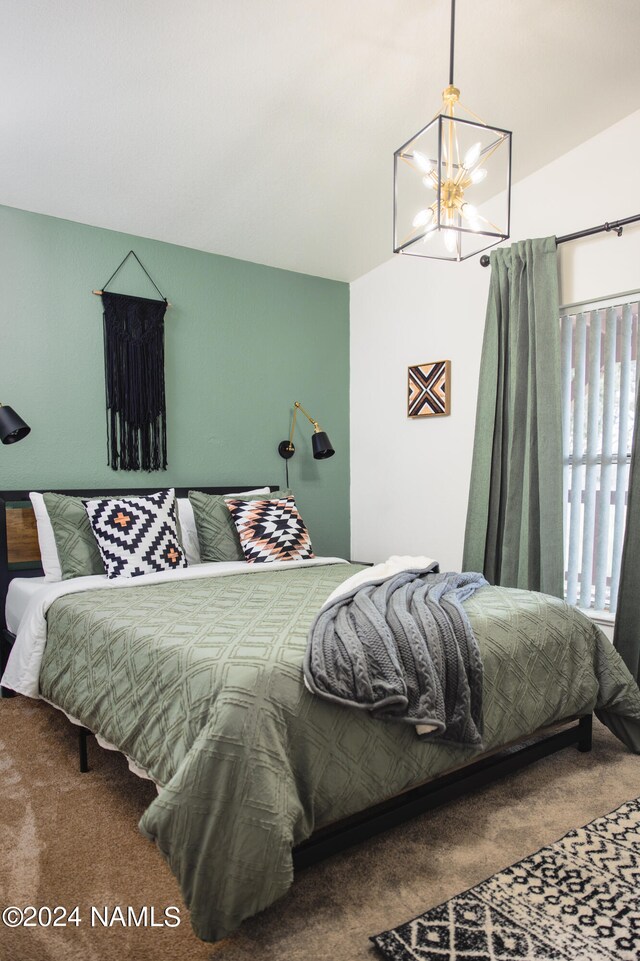 bedroom with lofted ceiling, a chandelier, and carpet flooring