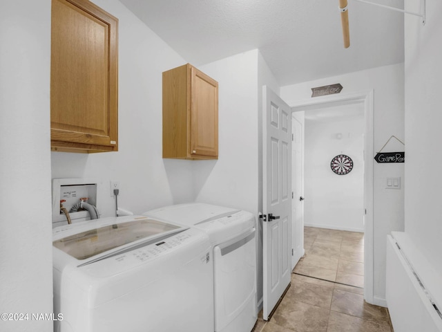 washroom featuring independent washer and dryer, cabinet space, and baseboards