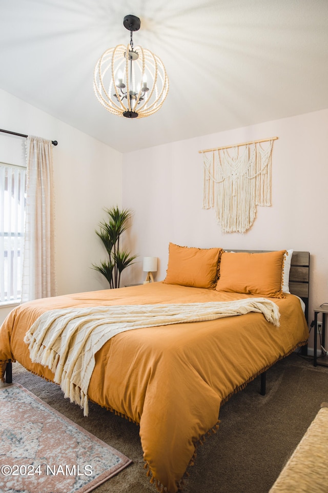 carpeted bedroom with a chandelier