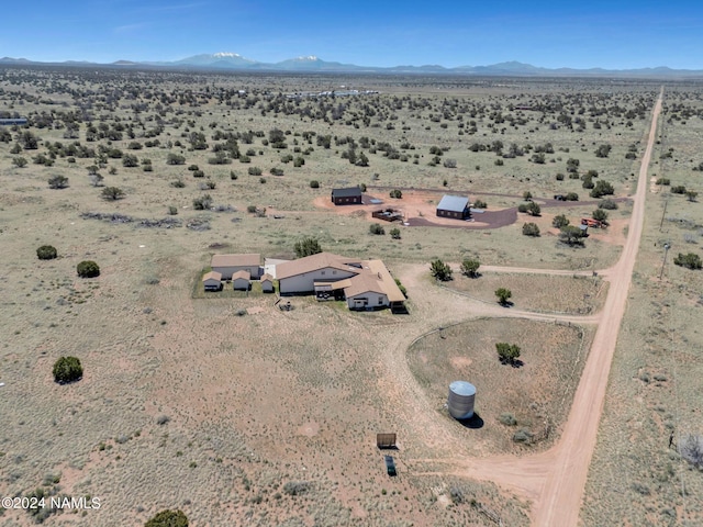 drone / aerial view with a mountain view, a desert view, and a rural view