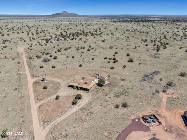 birds eye view of property with a mountain view and a desert view