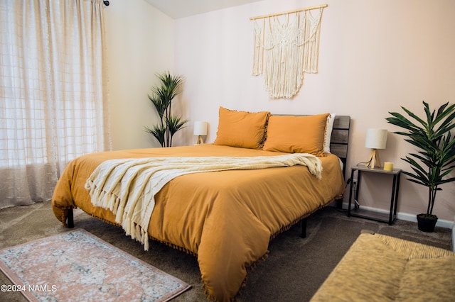 bedroom featuring carpet floors and baseboards