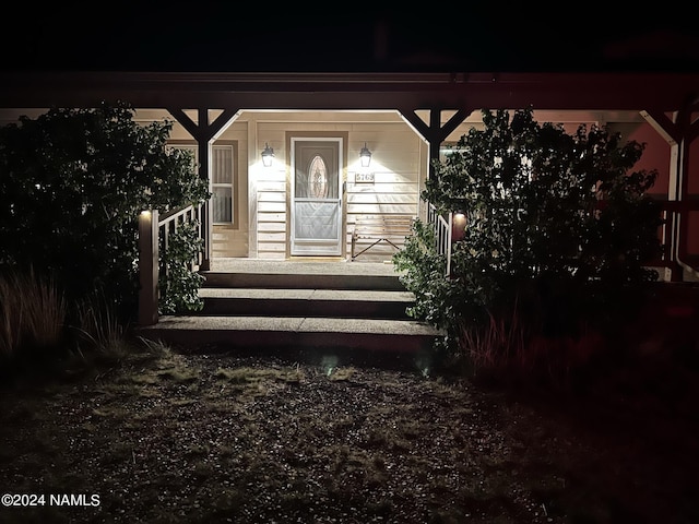 exterior entry at night with covered porch