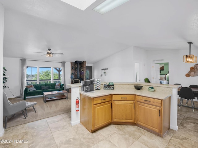 kitchen with visible vents, open floor plan, hanging light fixtures, light countertops, and ceiling fan with notable chandelier