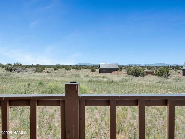 view of yard with a rural view and a mountain view