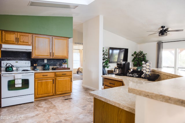 kitchen with electric range, vaulted ceiling, extractor fan, and a wealth of natural light