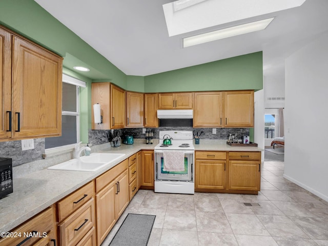 kitchen featuring under cabinet range hood, electric range, light countertops, and a sink