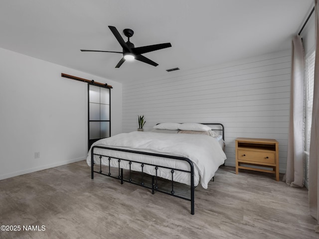 389 N Laramy Ln, Parks, AZ 86018 - bedroom with a barn door and ceiling fan