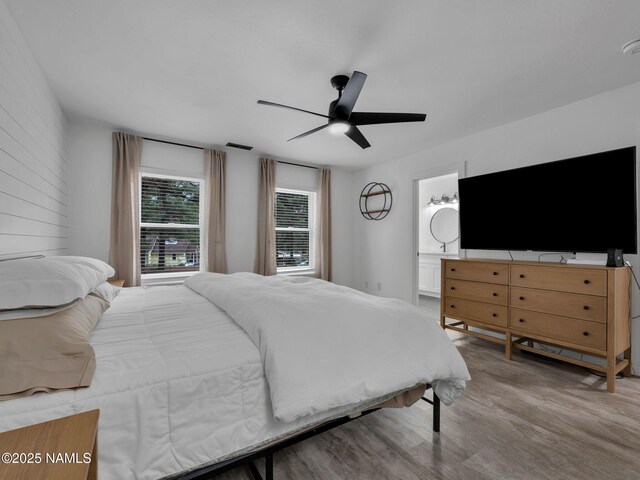 389 N Laramy Ln, Parks, AZ 86018 - bedroom featuring wood finished floors, ceiling fan, and ensuite bath