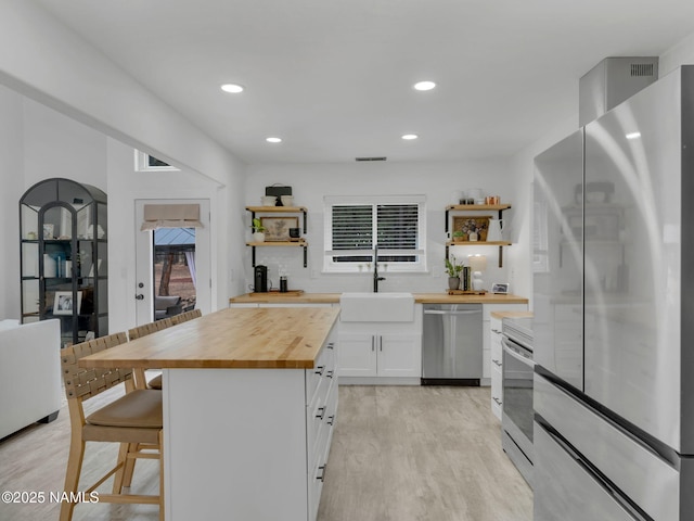 389 N Laramy Ln, Parks, AZ 86018 - kitchen with butcher block counters, appliances with stainless steel finishes, open shelves, a sink, and recessed lighting