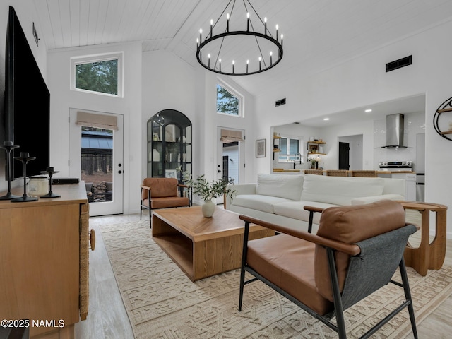 389 N Laramy Ln, Parks, AZ 86018 - living room featuring high vaulted ceiling, a chandelier, light wood-type flooring, and wood ceiling