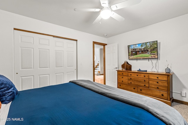 carpeted bedroom featuring a closet, baseboards, and ceiling fan