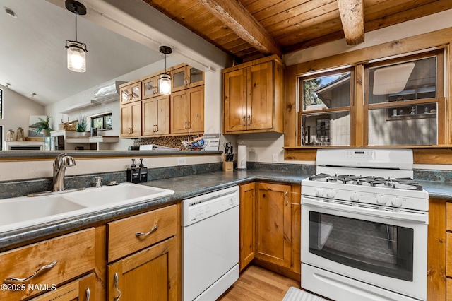 kitchen with white appliances, beamed ceiling, light wood-style floors, brown cabinets, and a sink