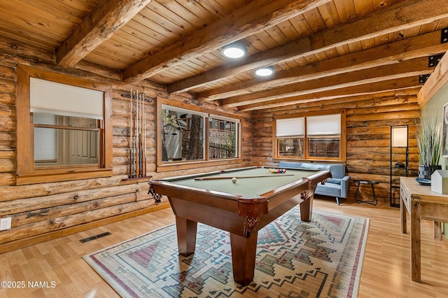 playroom with log walls, wood ceiling, and beam ceiling