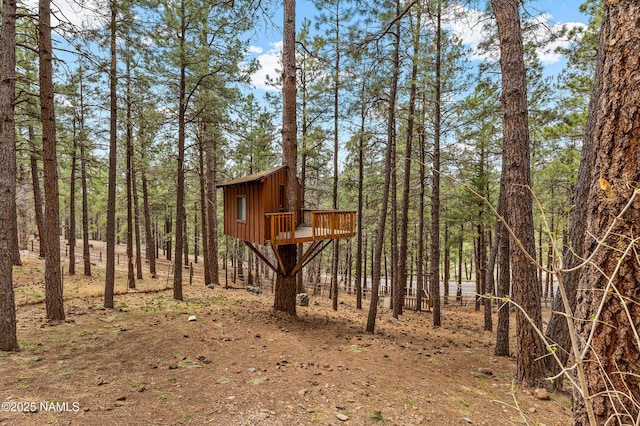 view of outdoor structure with a forest view