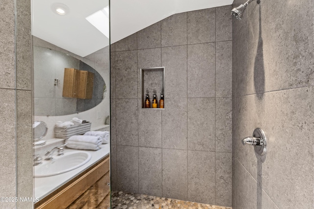 2856 Chaco Trl, Flagstaff, AZ 86005 - full bathroom with vanity, vaulted ceiling with skylight, and tiled shower