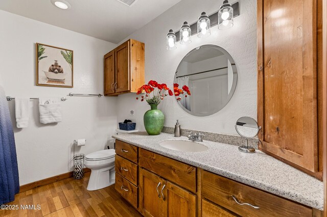2856 Chaco Trl, Flagstaff, AZ 86005 - bathroom with vanity, baseboards, toilet, and wood finished floors