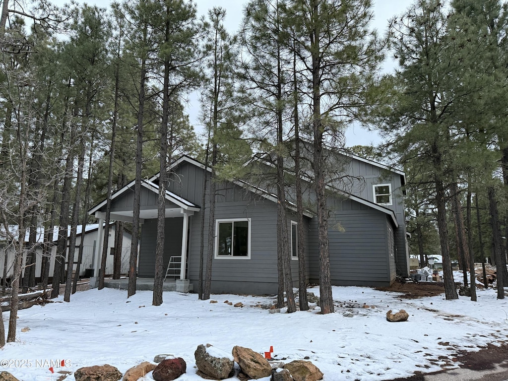 view of front of house with a garage, covered porch, and board and batten siding