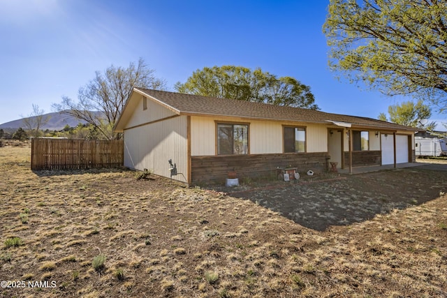 11280 N Zady Ln, Flagstaff, AZ 86004 - view of front facade with fence, a mountain view, and a garage