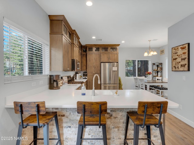 867 Onieda, Flagstaff, AZ 86005 - kitchen featuring stainless steel appliances, a peninsula, light wood-style floors, plenty of natural light, and recessed lighting