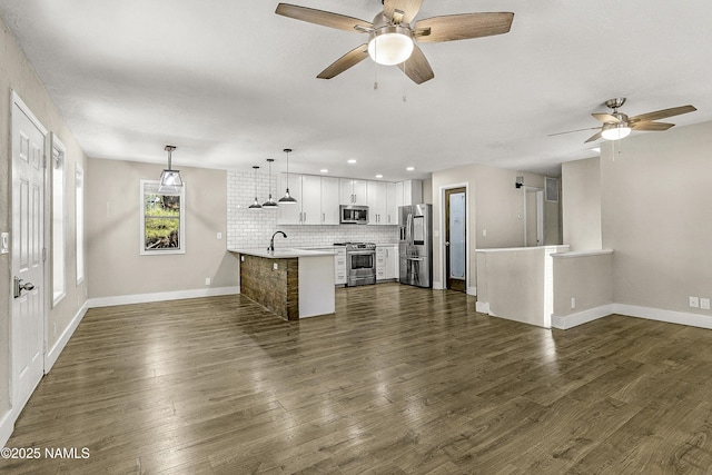 4573 Canyon Loop, Flagstaff, AZ 86005 - unfurnished living room with a ceiling fan, baseboards, dark wood finished floors, and recessed lighting