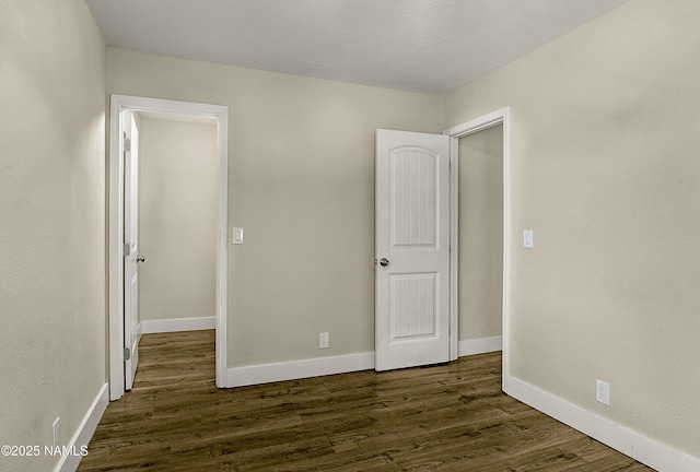 4573 Canyon Loop, Flagstaff, AZ 86005 - unfurnished bedroom featuring dark wood finished floors and baseboards