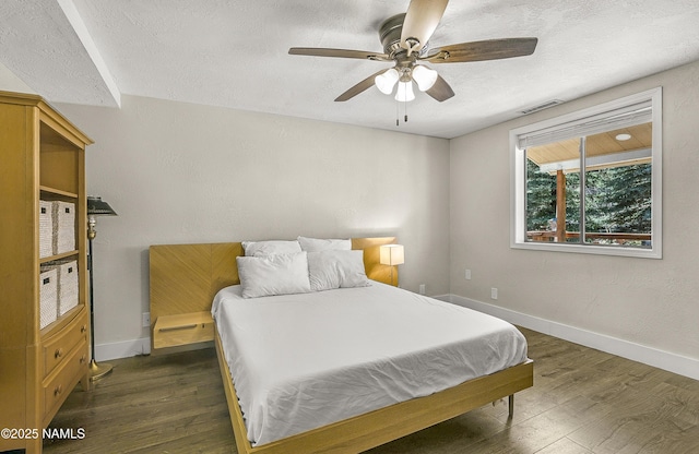 4573 Canyon Loop, Flagstaff, AZ 86005 - bedroom with a textured ceiling, dark wood finished floors, baseboards, and a ceiling fan