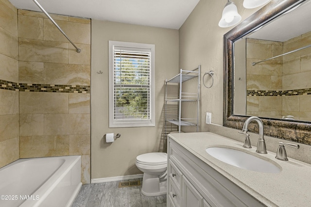 4573 Canyon Loop, Flagstaff, AZ 86005 - bathroom featuring toilet, vanity, shower / bath combination, wood finished floors, and baseboards