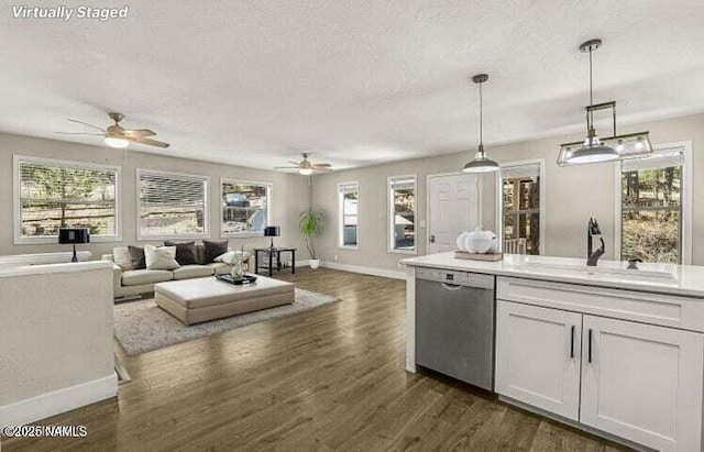 4573 Canyon Loop, Flagstaff, AZ 86005 - kitchen featuring dishwasher, a sink, ceiling fan, a textured ceiling, and open floor plan
