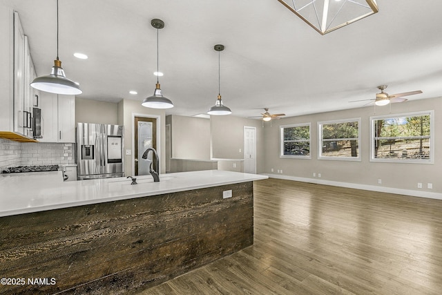 4573 Canyon Loop, Flagstaff, AZ 86005 - kitchen featuring stainless steel appliances, a peninsula, a ceiling fan, a sink, and wood finished floors