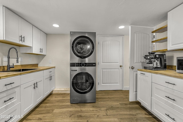 4573 Canyon Loop, Flagstaff, AZ 86005 - laundry room with estacked washer and dryer, dark wood-type flooring, and recessed lighting