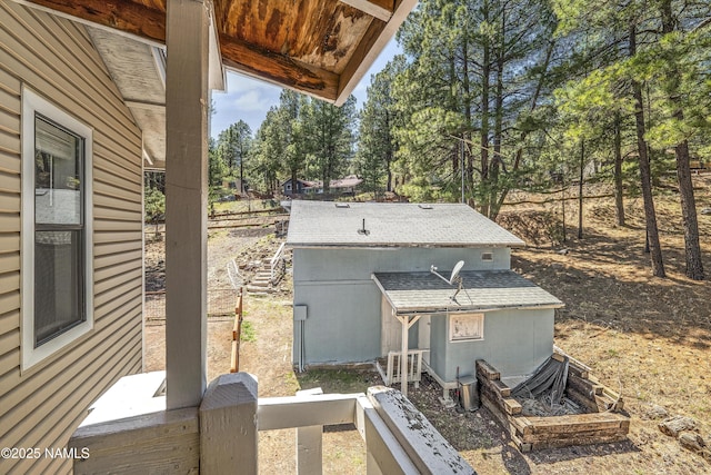 4573 Canyon Loop, Flagstaff, AZ 86005 - view of home's exterior featuring roof with shingles and view of scattered trees