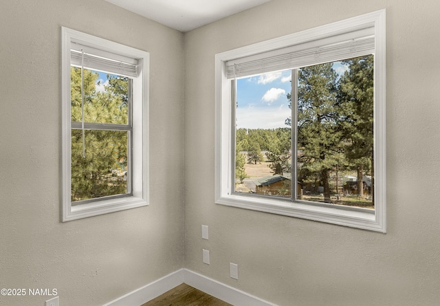 4573 Canyon Loop, Flagstaff, AZ 86005 - empty room with baseboards, plenty of natural light, and wood finished floors