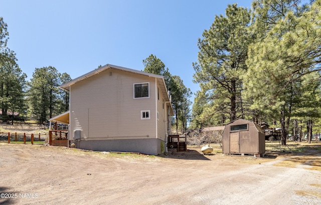 4573 Canyon Loop, Flagstaff, AZ 86005 - view of side of property with a storage shed, an outdoor structure, and fence