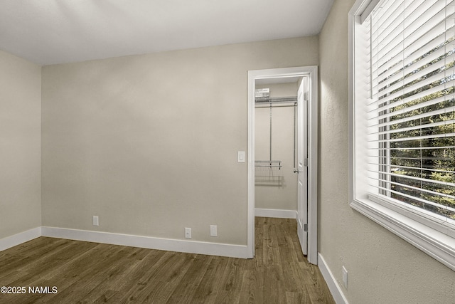 4573 Canyon Loop, Flagstaff, AZ 86005 - unfurnished bedroom featuring wood finished floors, baseboards, and a spacious closet