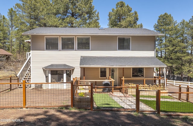 4573 Canyon Loop, Flagstaff, AZ 86005 - view of front of home with a porch, a fenced front yard, a gate, and roof with shingles
