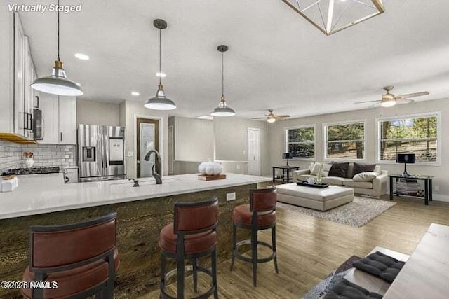 4573 Canyon Loop, Flagstaff, AZ 86005 - kitchen with appliances with stainless steel finishes, a peninsula, a ceiling fan, a sink, and recessed lighting