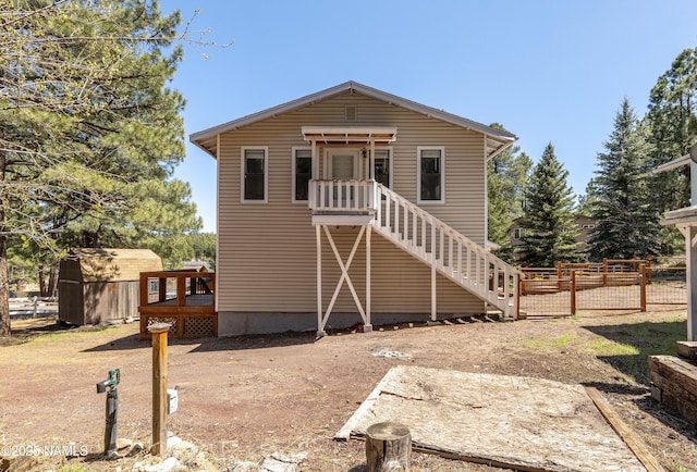 4573 Canyon Loop, Flagstaff, AZ 86005 - view of front of home featuring a storage shed, an outdoor structure, stairway, fence, and a wooden deck