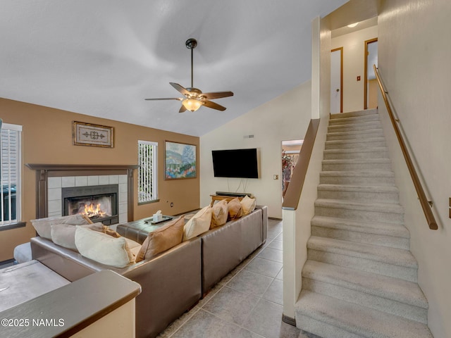 3114 N Connor St, Flagstaff, AZ 86004 - living room with a ceiling fan, stairs, a tile fireplace, light tile patterned flooring, and vaulted ceiling